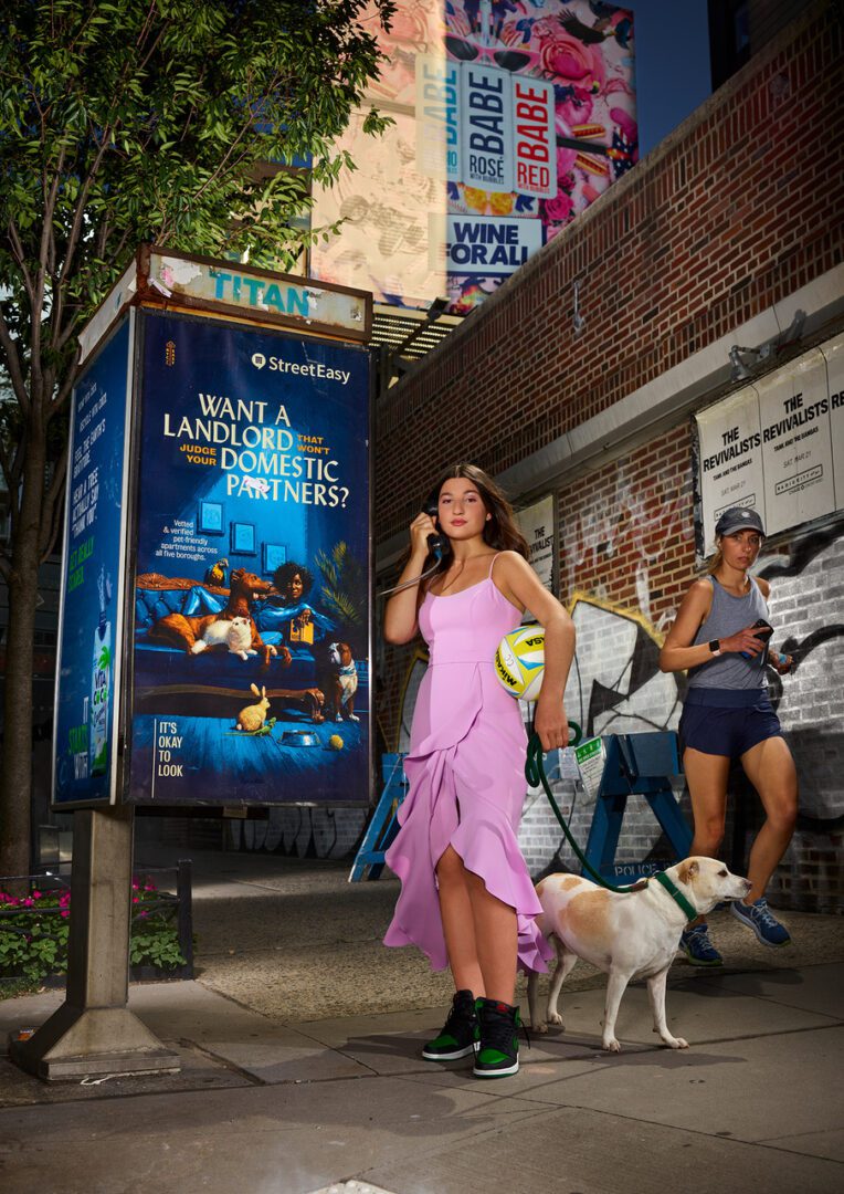 A woman in a pink dress and two dogs