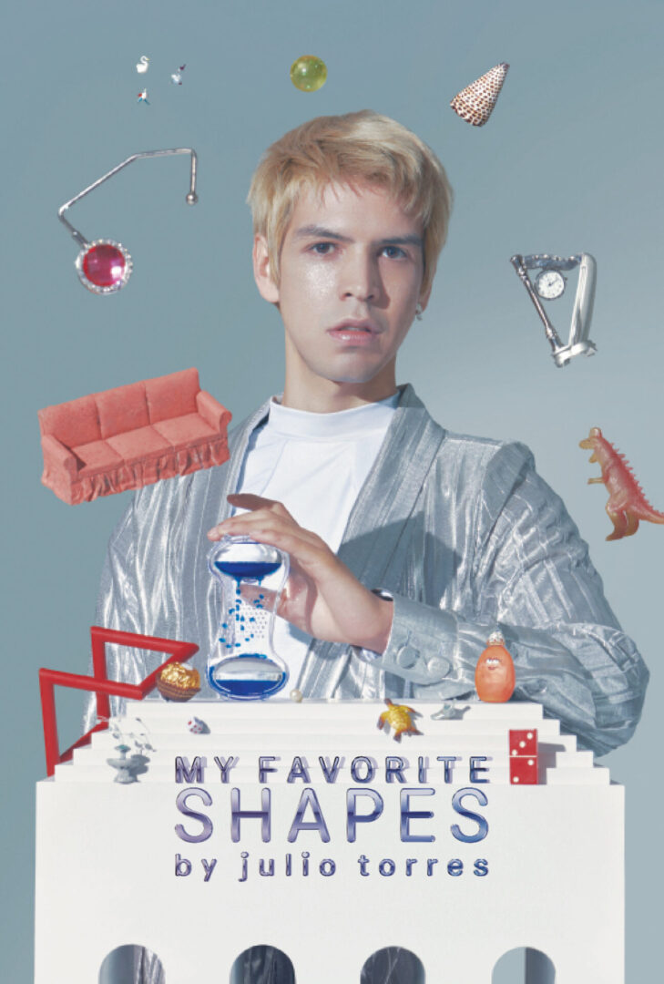 A man with a silver jacket and some objects